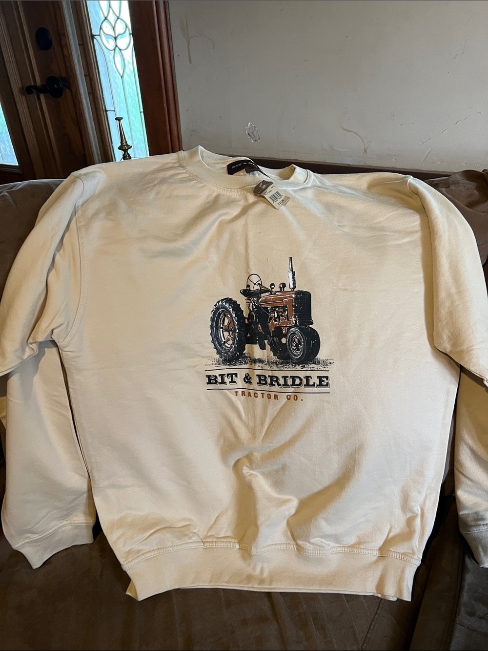 Bit & Bridle Cream Sweatshirt with Brown Tractor Graphic